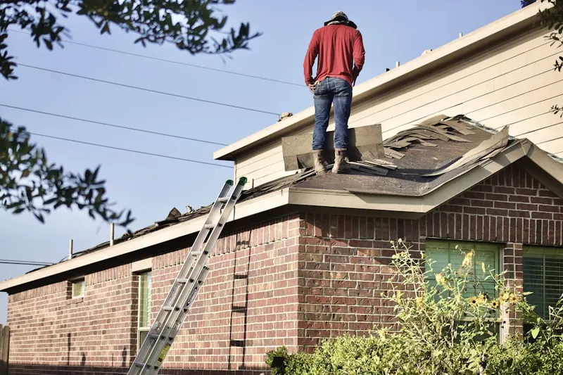 Professional roofer working on a residential roof in Stilwell